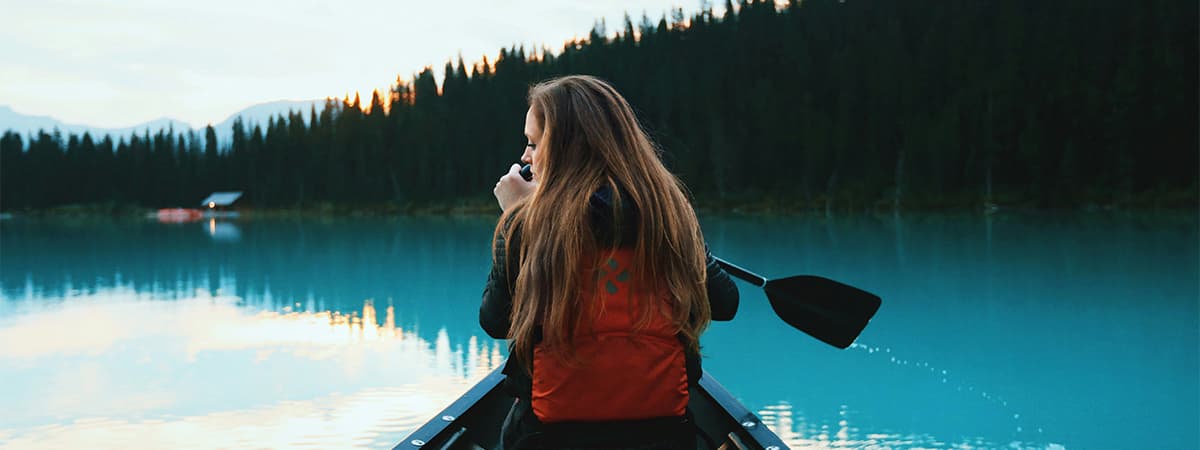 A visitor canoeing on a Canadian lake